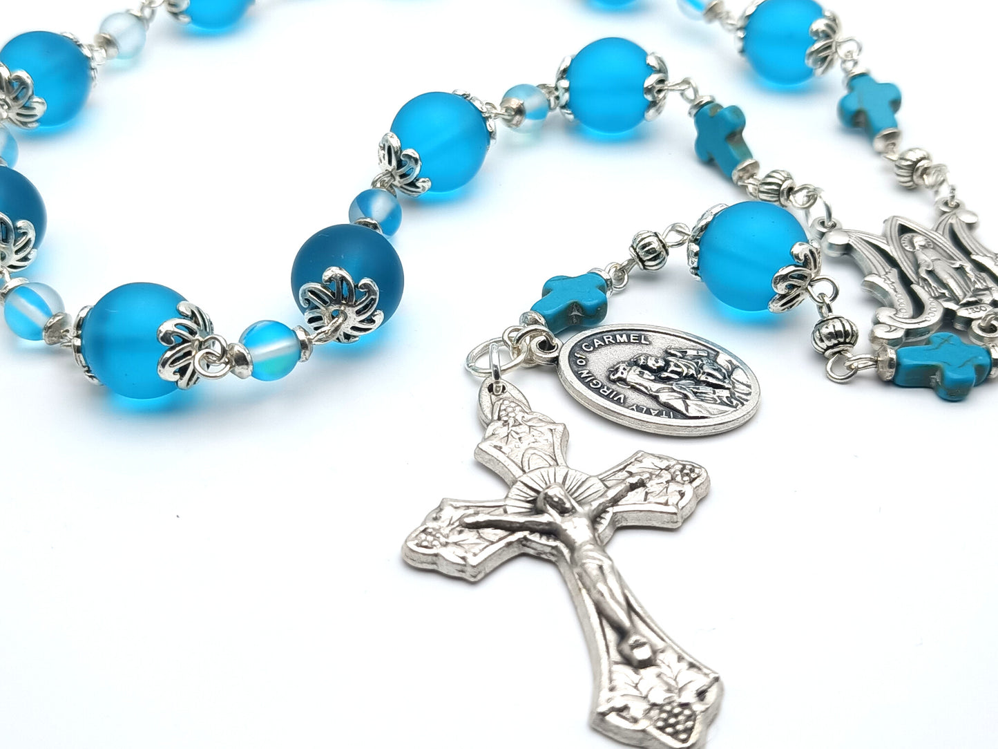 Our Lady of Mount Carmel unique rosary beads single decade with blue glass beads, silver miraculous medal centre medal, vine leaves crucifix and Our Lady of Mount Carmel medal.