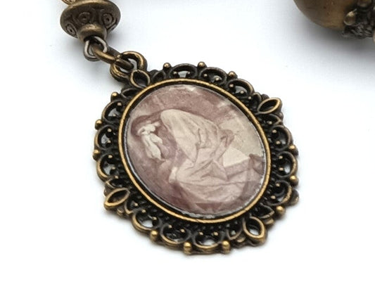 Saint Mary Magdalene unique rosary beads prayer chaplet with red gemstone beads, bronze bead caps, picture end medal and silver Holy Spirit picture centre medal.