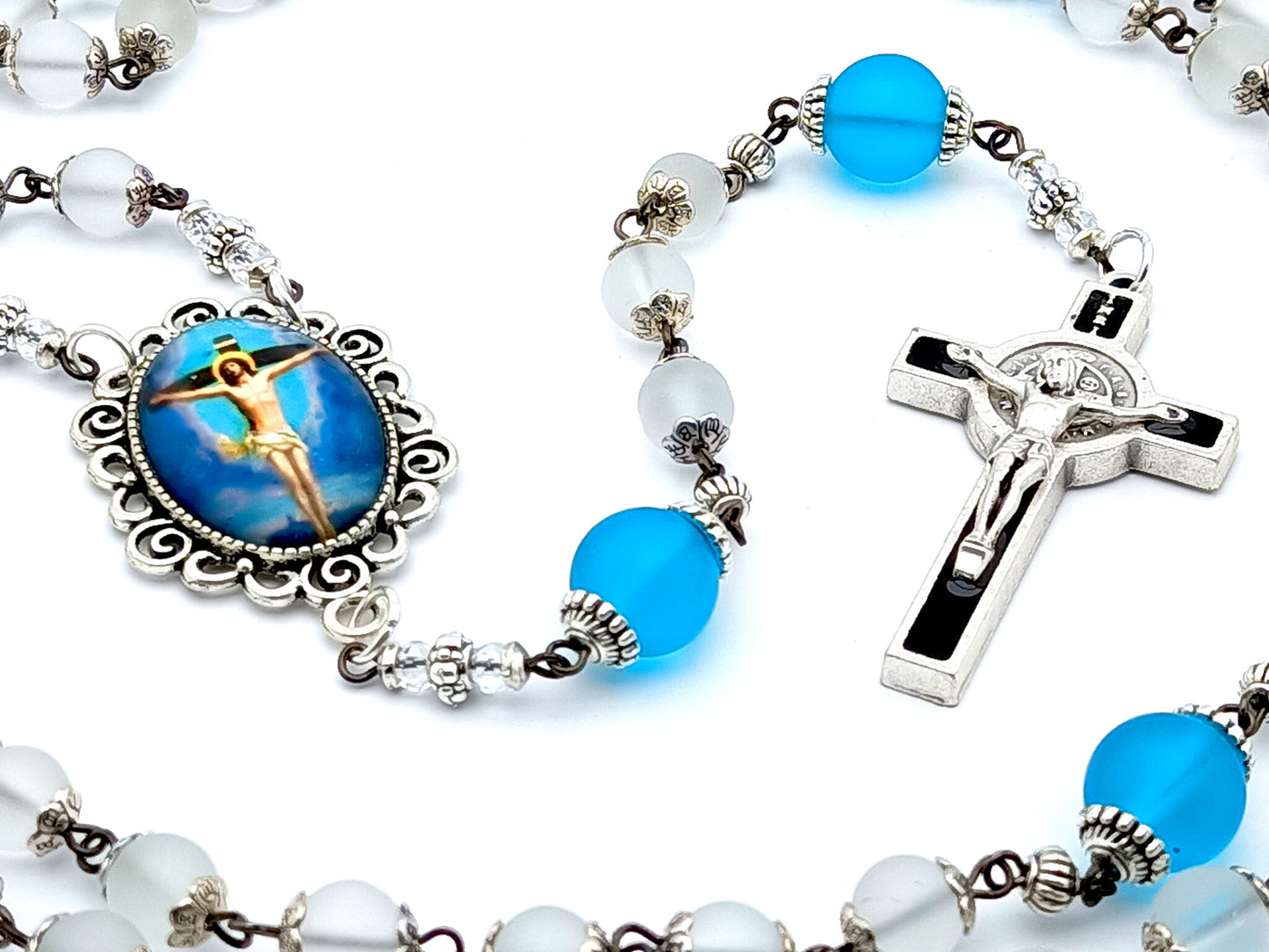 The Crucifixion unique rosary beads with frosted clear and blue glass beads, black and silver enamel crucifix and picture centre medal.