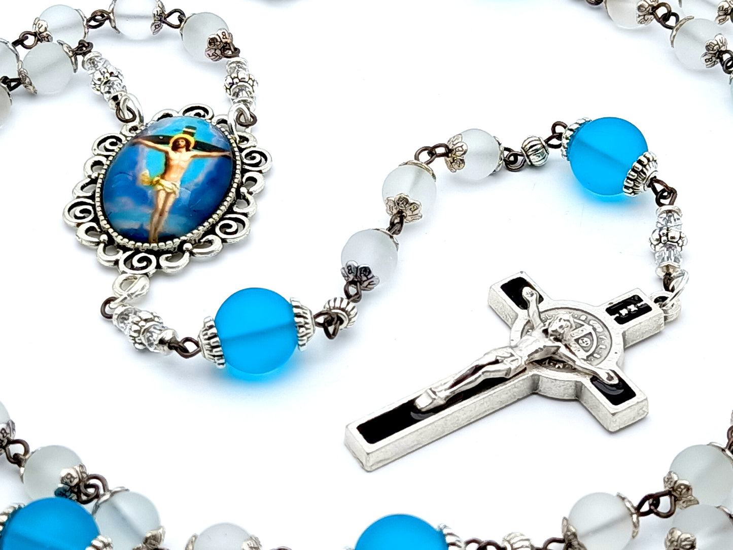 The Crucifixion unique rosary beads with frosted clear and blue glass beads, black and silver enamel crucifix and picture centre medal.