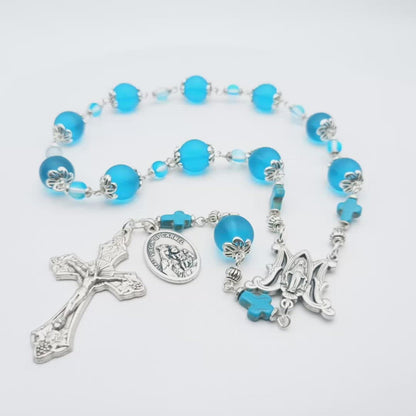 Our Lady of Mount Carmel unique rosary beads single decade with blue glass beads, silver miraculous medal centre medal, vine leaves crucifix and Our Lady of Mount Carmel medal.