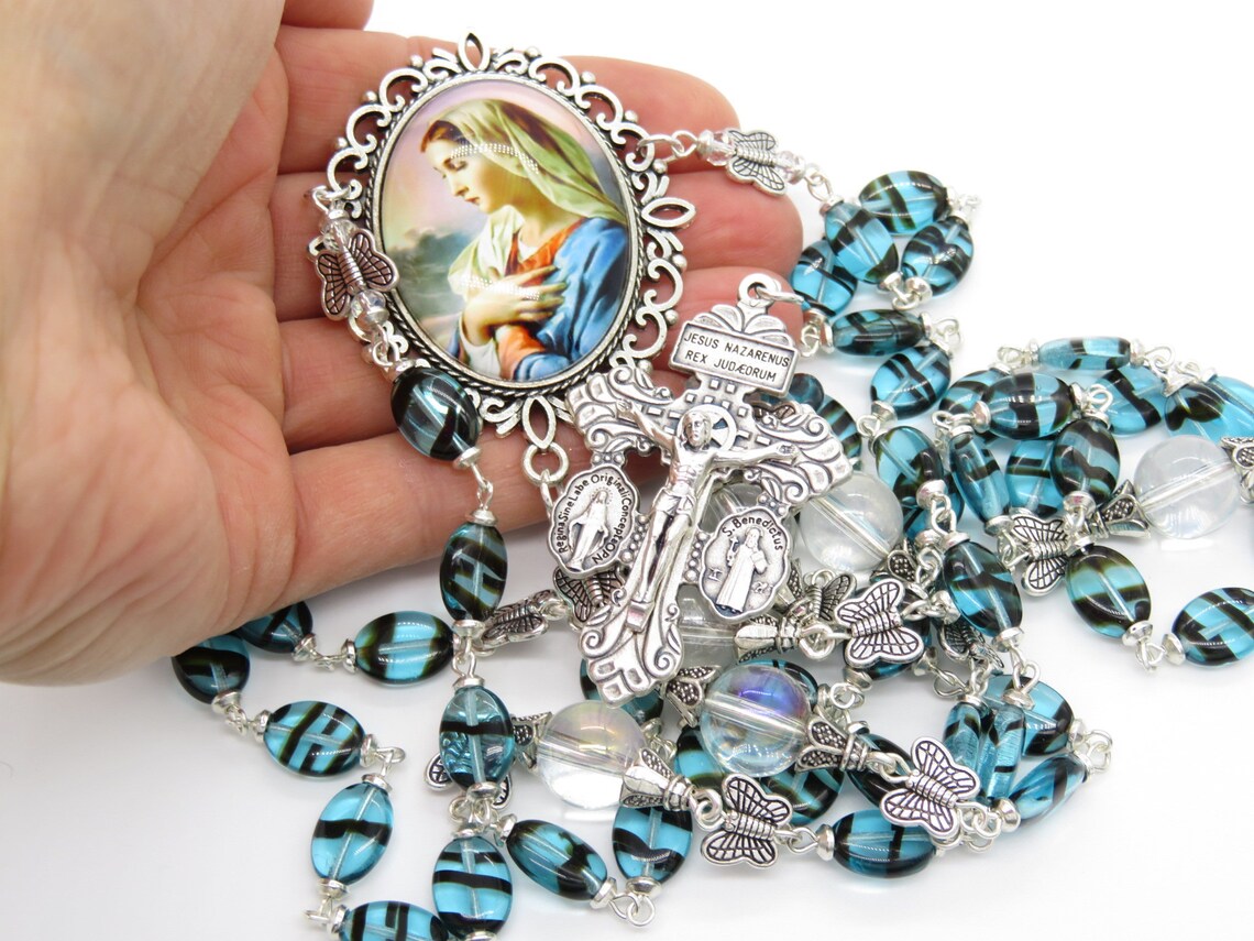 Virgin Marys Fiat unique rosary beads with blue oval glass beads, silver butterfly beads, silver pardon crucifix and picture centre medal.