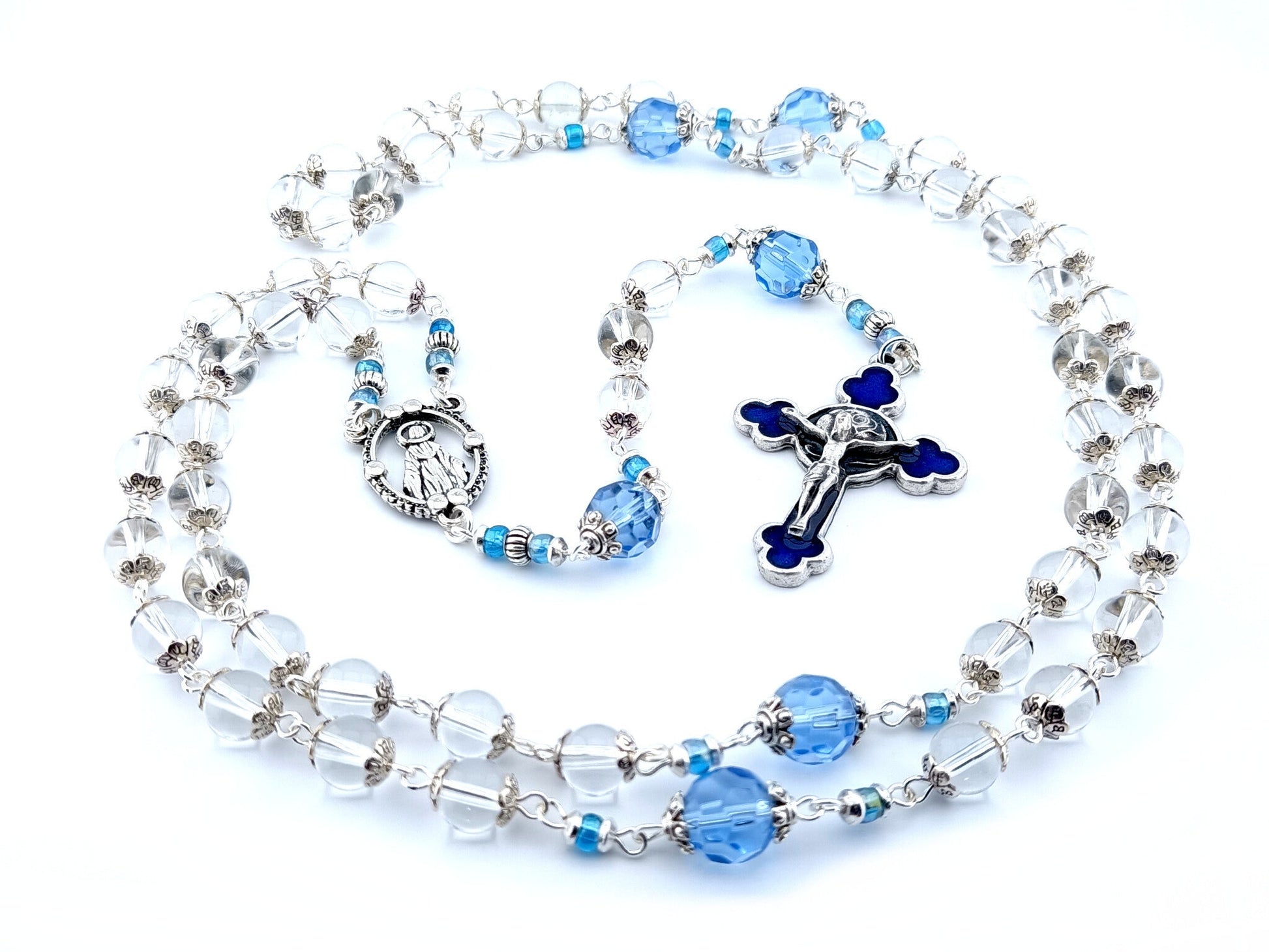 Our Lady of Grace unique rosary beads with clear glass beads, faceted blue glass pater beads, blue enamel crucifix and silver centre medal.