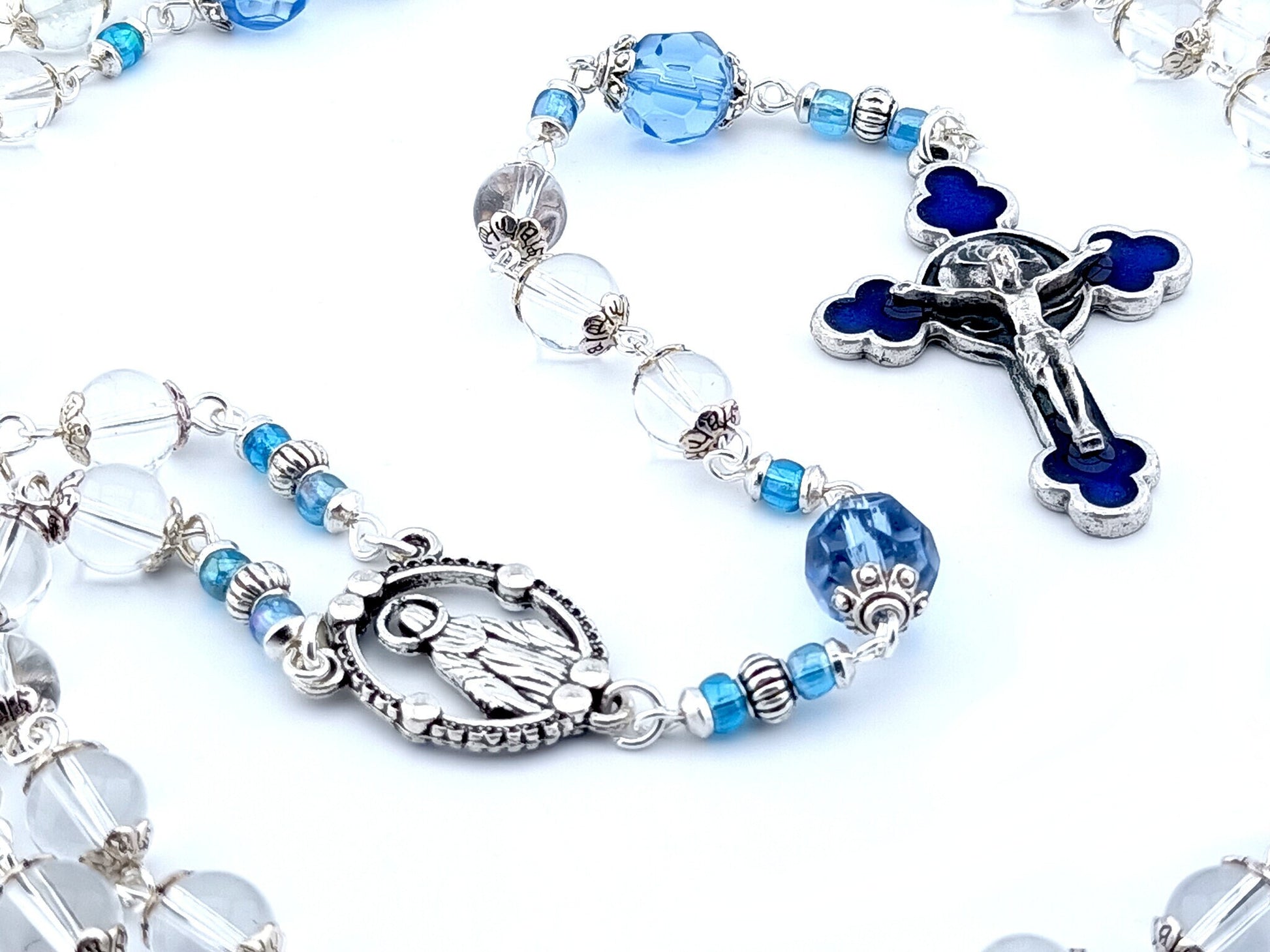 Our Lady of Grace unique rosary beads with clear glass beads, faceted blue glass pater beads, blue enamel crucifix and silver centre medal.