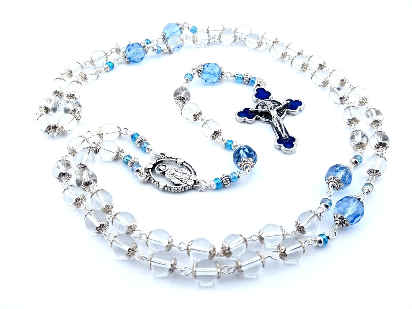 Our Lady of Grace unique rosary beads with clear glass beads, faceted blue glass pater beads, blue enamel crucifix and silver centre medal.