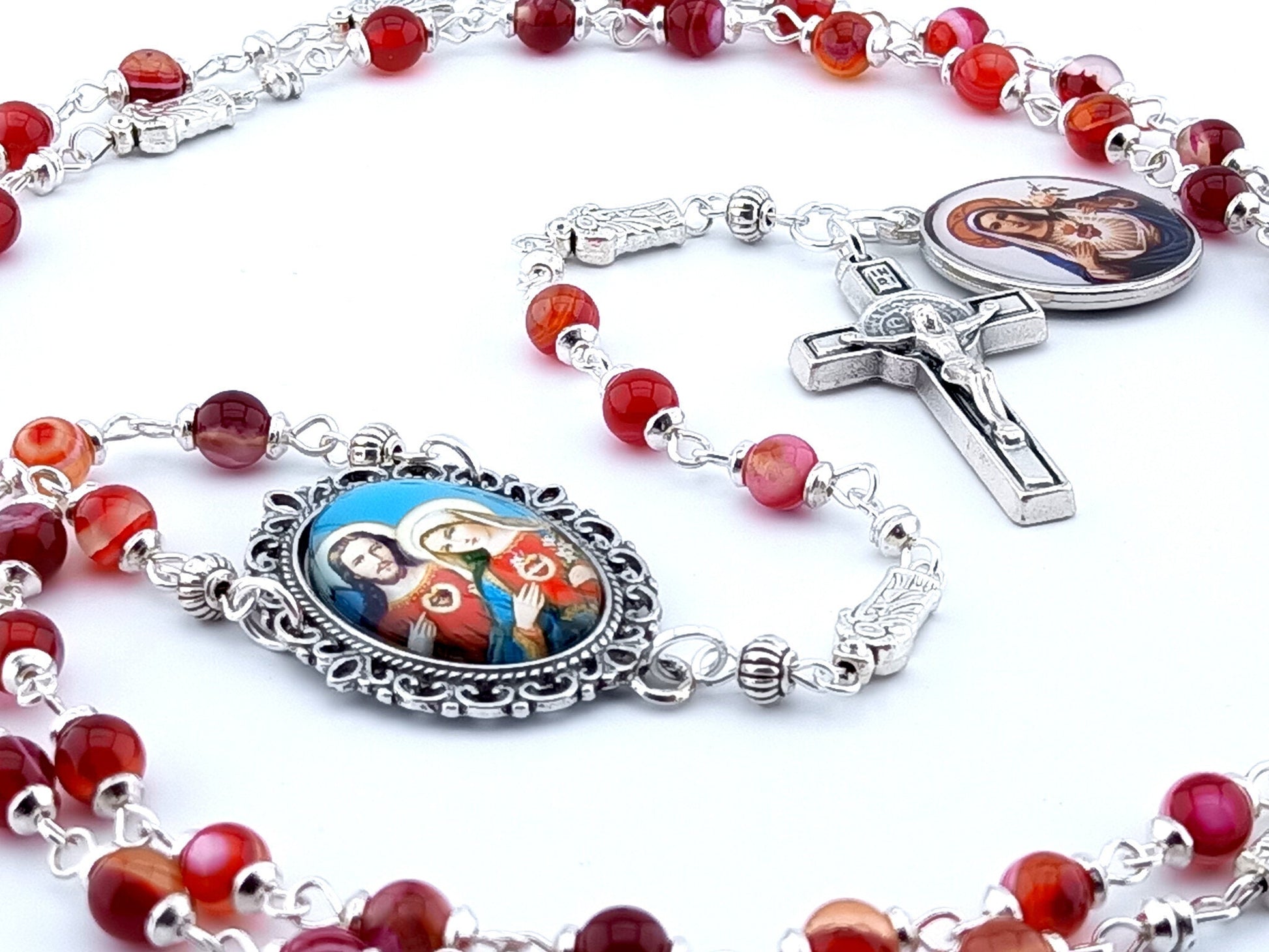 The two Hearts of Jesus and Mary unique rosary beads with red agate gemstone beads, silver Saint Benedict crucifix, picture centre medal and pater beads.