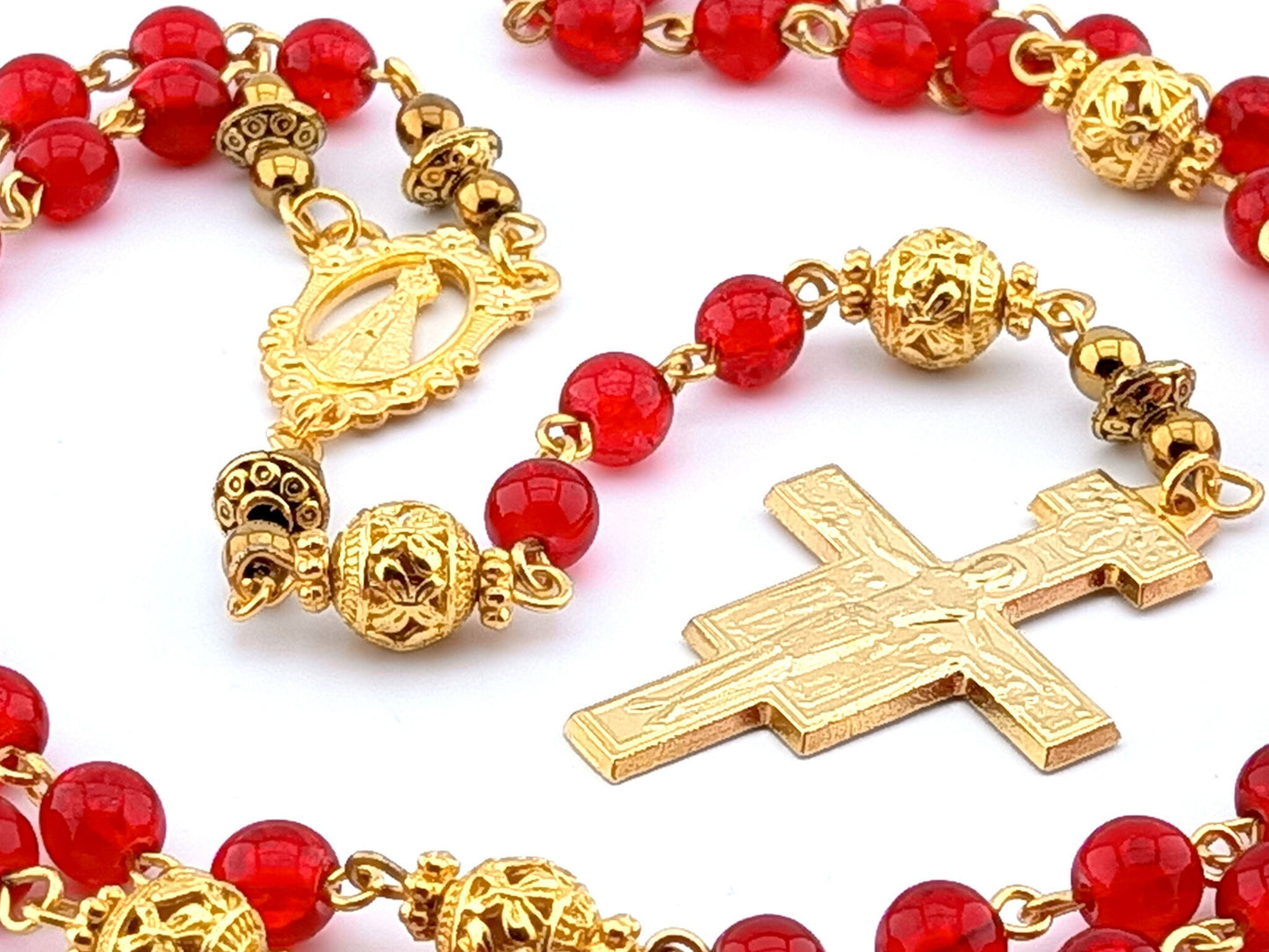 Our Lady of Loretto unique rosary beads with red glass and gold beads, golden Saint Francis crucifix and centre medal.