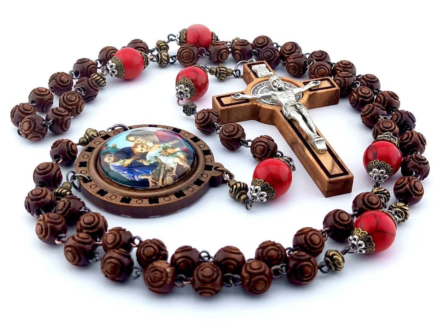 The Nativity unique rosary beads with carved wooden beads, Saint Benedict crucifix, picture centre medal and large red gemstone pater beads.