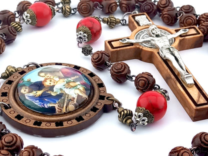 The Nativity unique rosary beads with carved wooden beads, Saint Benedict crucifix, picture centre medal and large red gemstone pater beads.