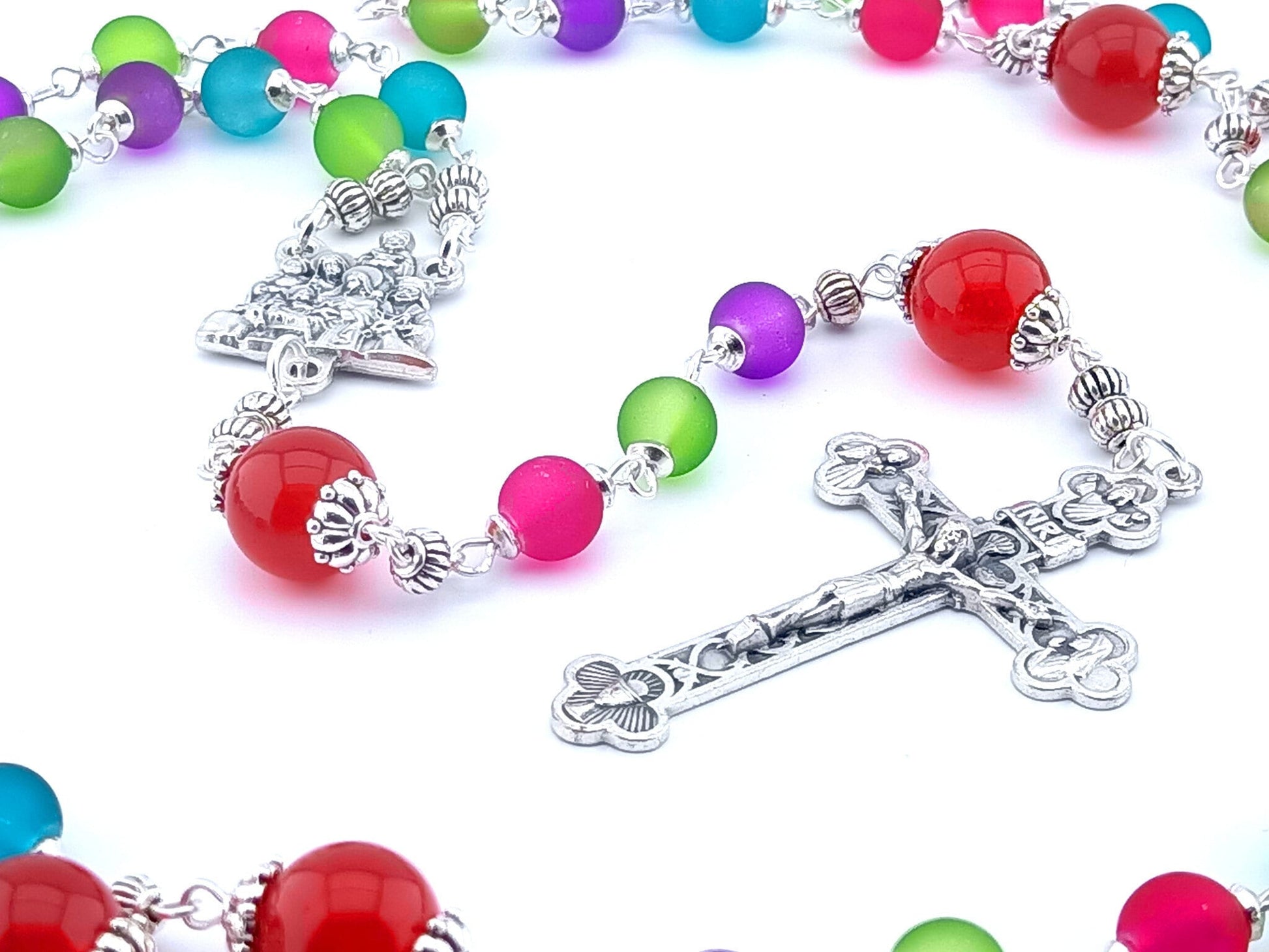 The Nativity unique rosary beads with multicoloured glass beads, silver Holy Spirit crucifix, Nativity centre medal and silver linking beads.