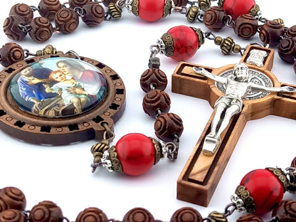 The Nativity unique rosary beads with carved wooden beads, Saint Benedict crucifix, picture centre medal and large red gemstone pater beads.