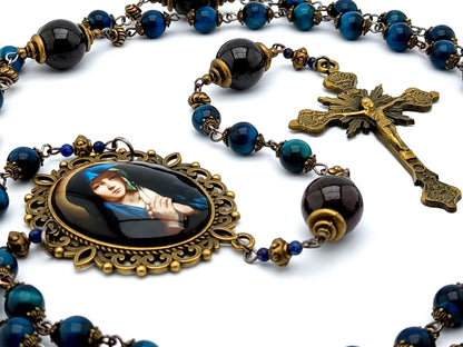 Our Lady unique rosary beads with blue tigers eye gemstone beads, brass sunburst crucifix, garnet pater beads and large brass picture centre medal.