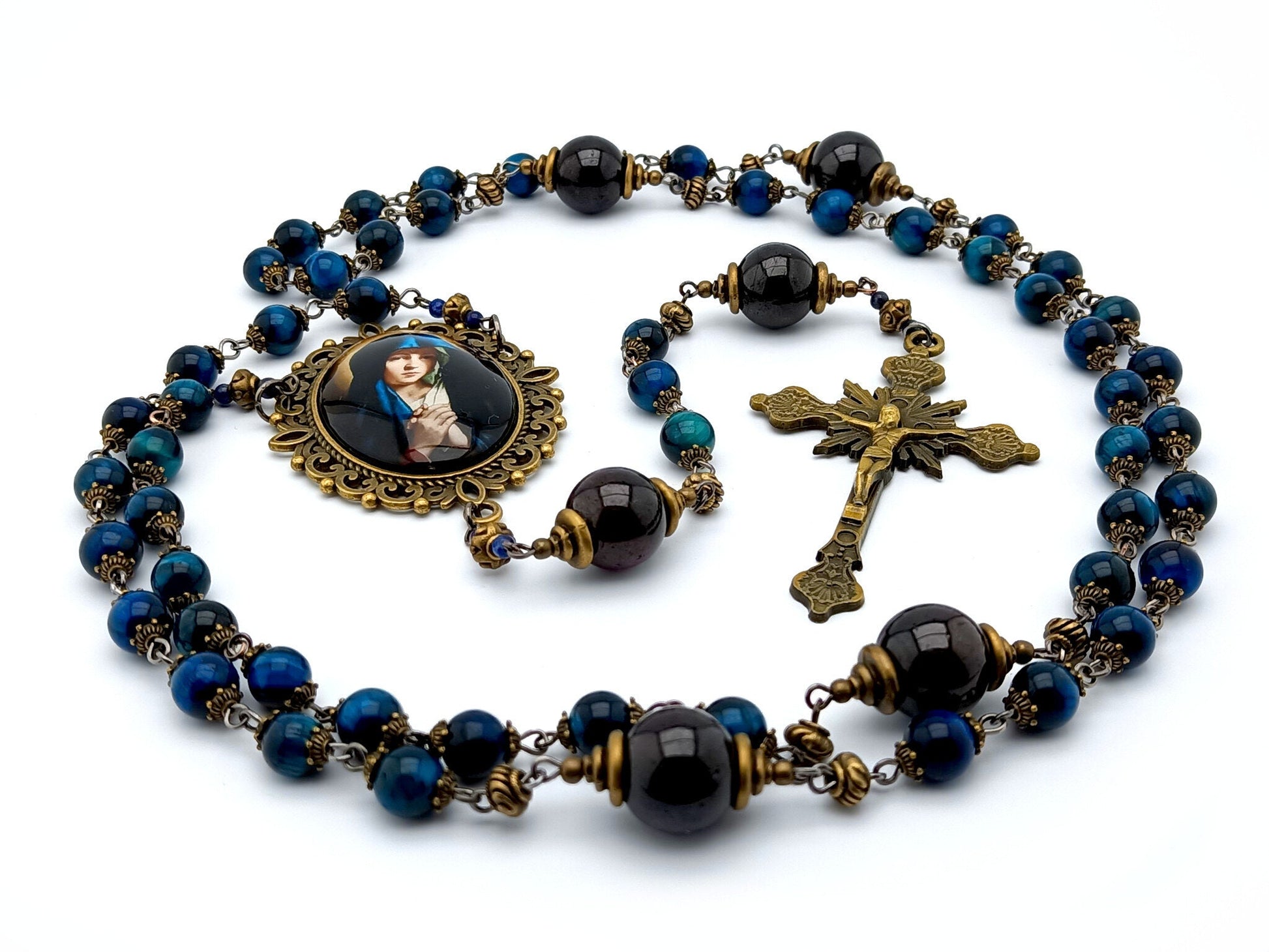 Our Lady unique rosary beads with blue tigers eye gemstone beads, brass sunburst crucifix, garnet pater beads and large brass picture centre medal.