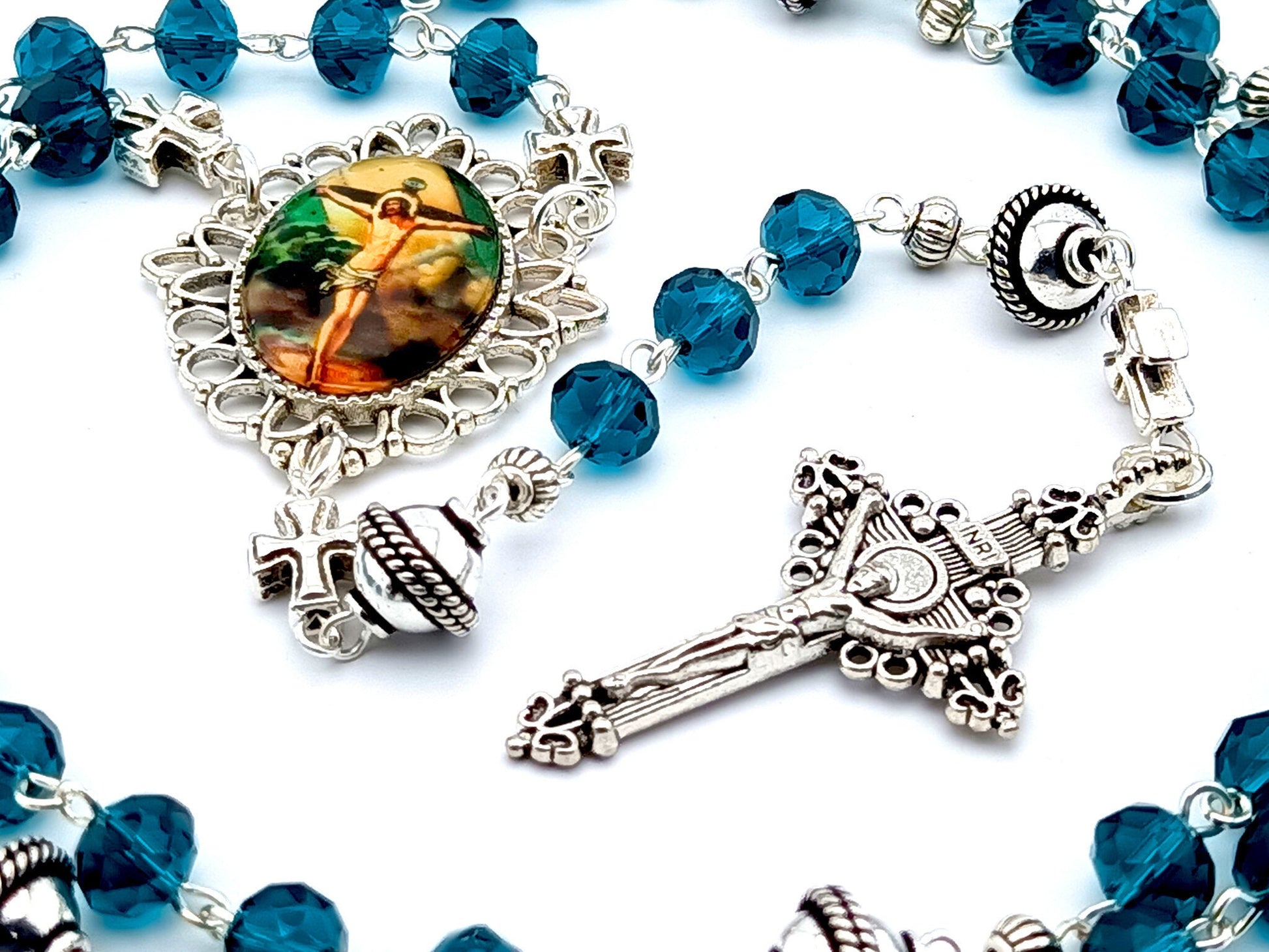 The Crucifixion unique rosary beads with blue faceted glass and silver beads, silver crucifix and picture centre medal.