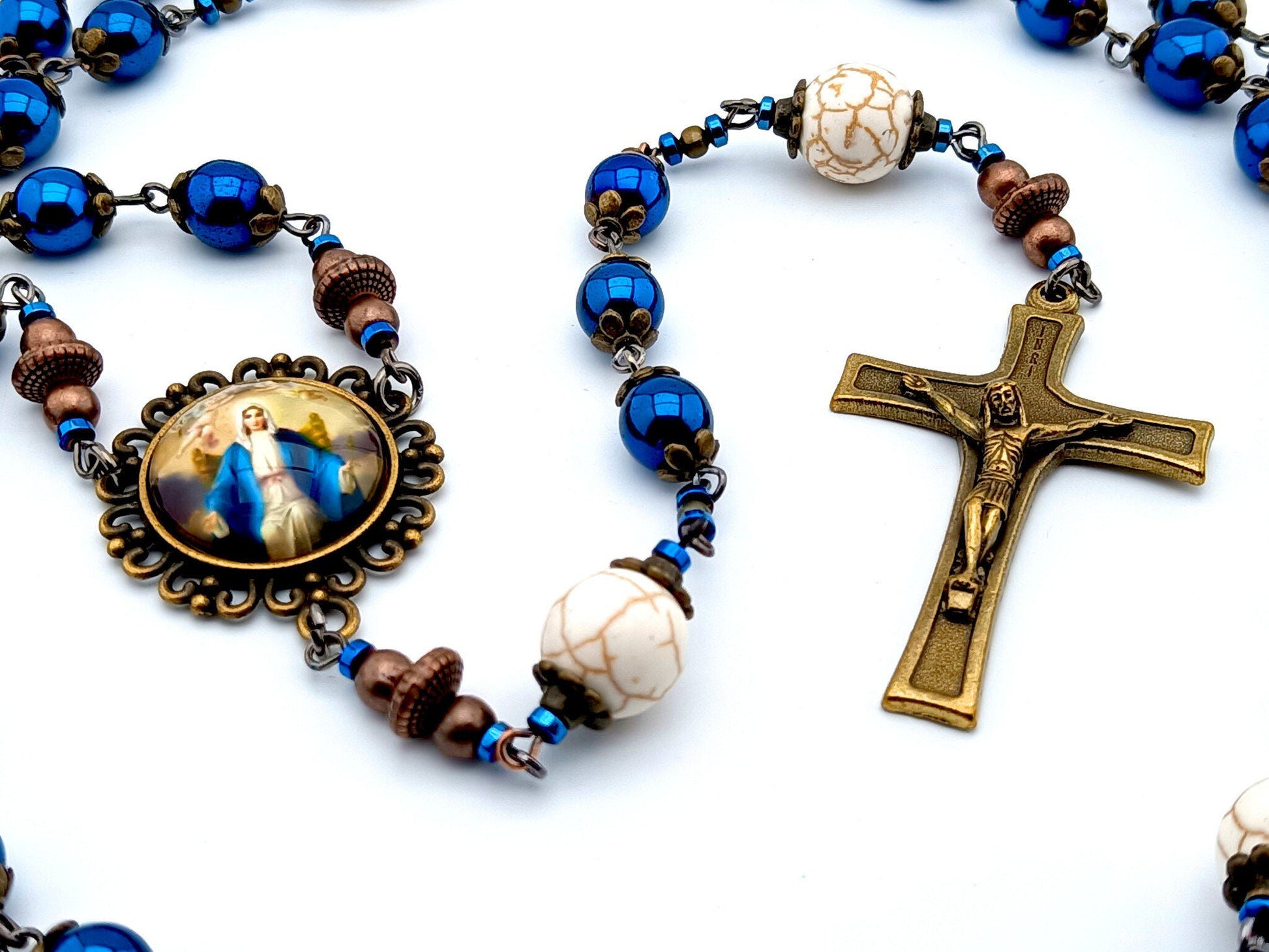 Our Lady Queen of Heaven unique rosary beads with blue hematite beads, bronze crucifix bead caps and picture centre medal.