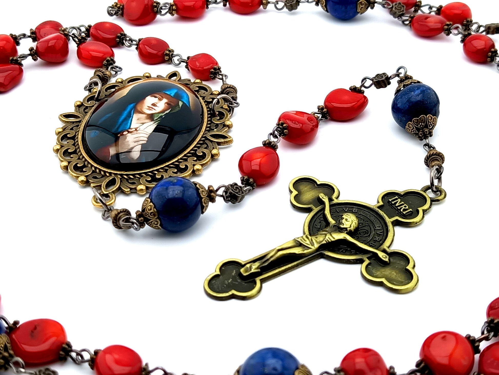Our Lady of Sorrows unique rosary beads with red gemstone beads, lapis lazuli pater beads, bronze picture centre medal and crucifix.