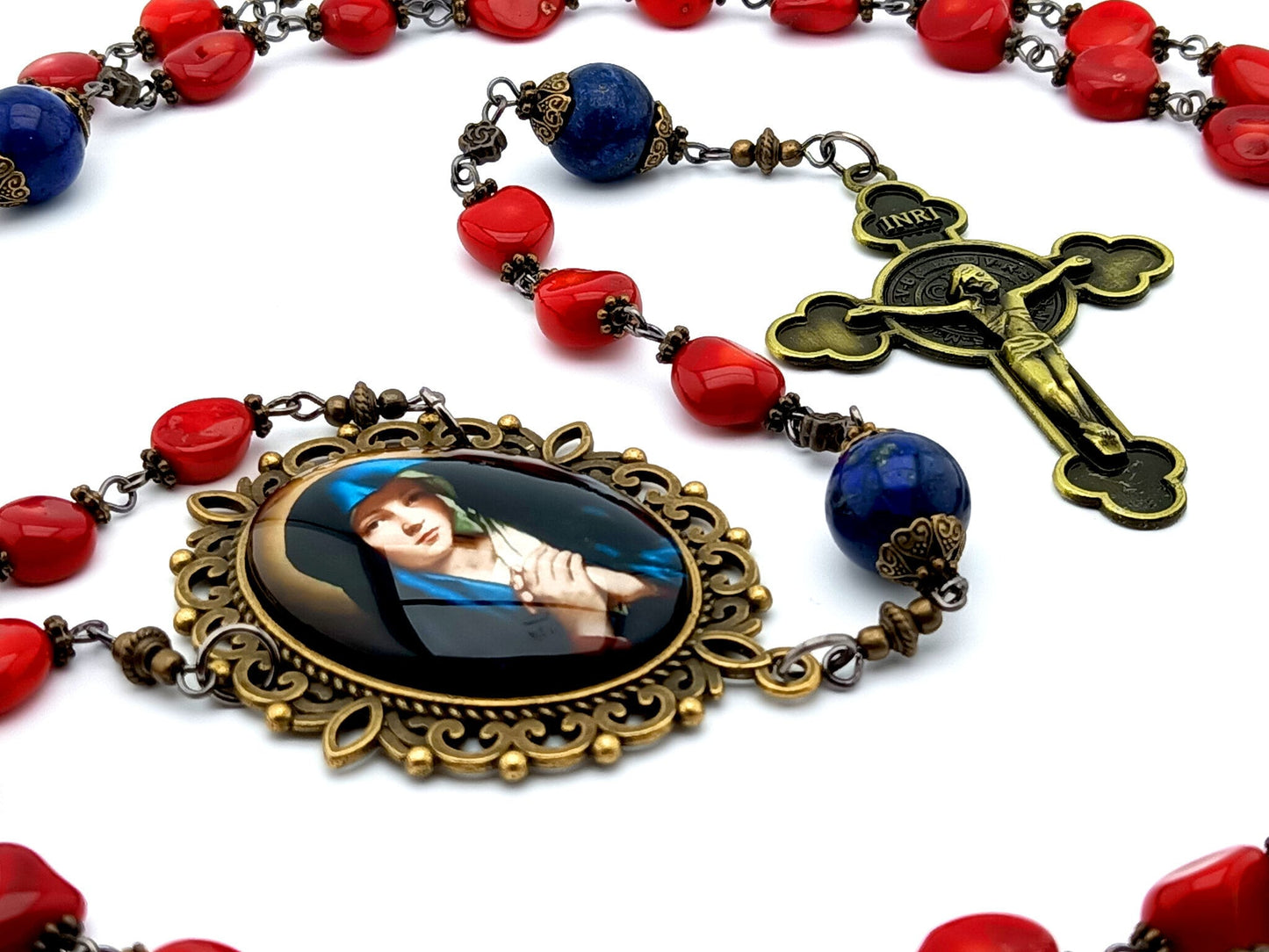 Our Lady of Sorrows unique rosary beads with red gemstone beads, lapis lazuli pater beads, bronze picture centre medal and crucifix.