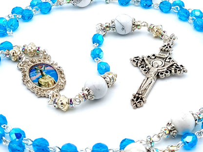 The Crucifixion unique rosary beads with blue faceted glass beads, silver crucifix and picture centre medal.