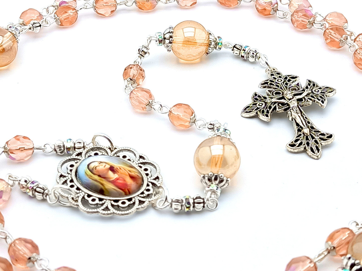 Virgin Mary unique rosary beads with rose gold faceted glass beads, silver filigree crucifix and picture centre medal.