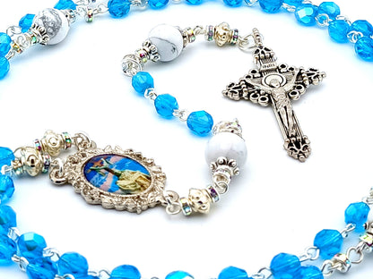 The Crucifixion unique rosary beads with blue faceted glass beads, silver crucifix and picture centre medal.