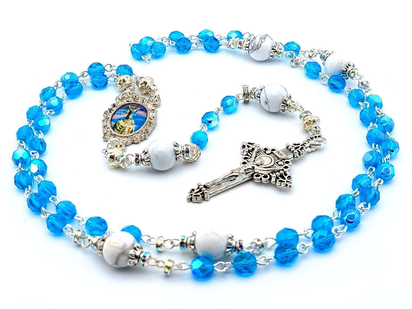 The Crucifixion unique rosary beads with blue faceted glass beads, silver crucifix and picture centre medal.