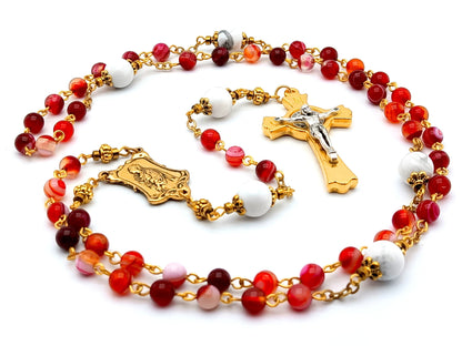 Saint John Vianney unique rosary beads with red agate and white gemstone beads, gold and silver Saint Benedict crucifix and small Saint Philomena centre medal.