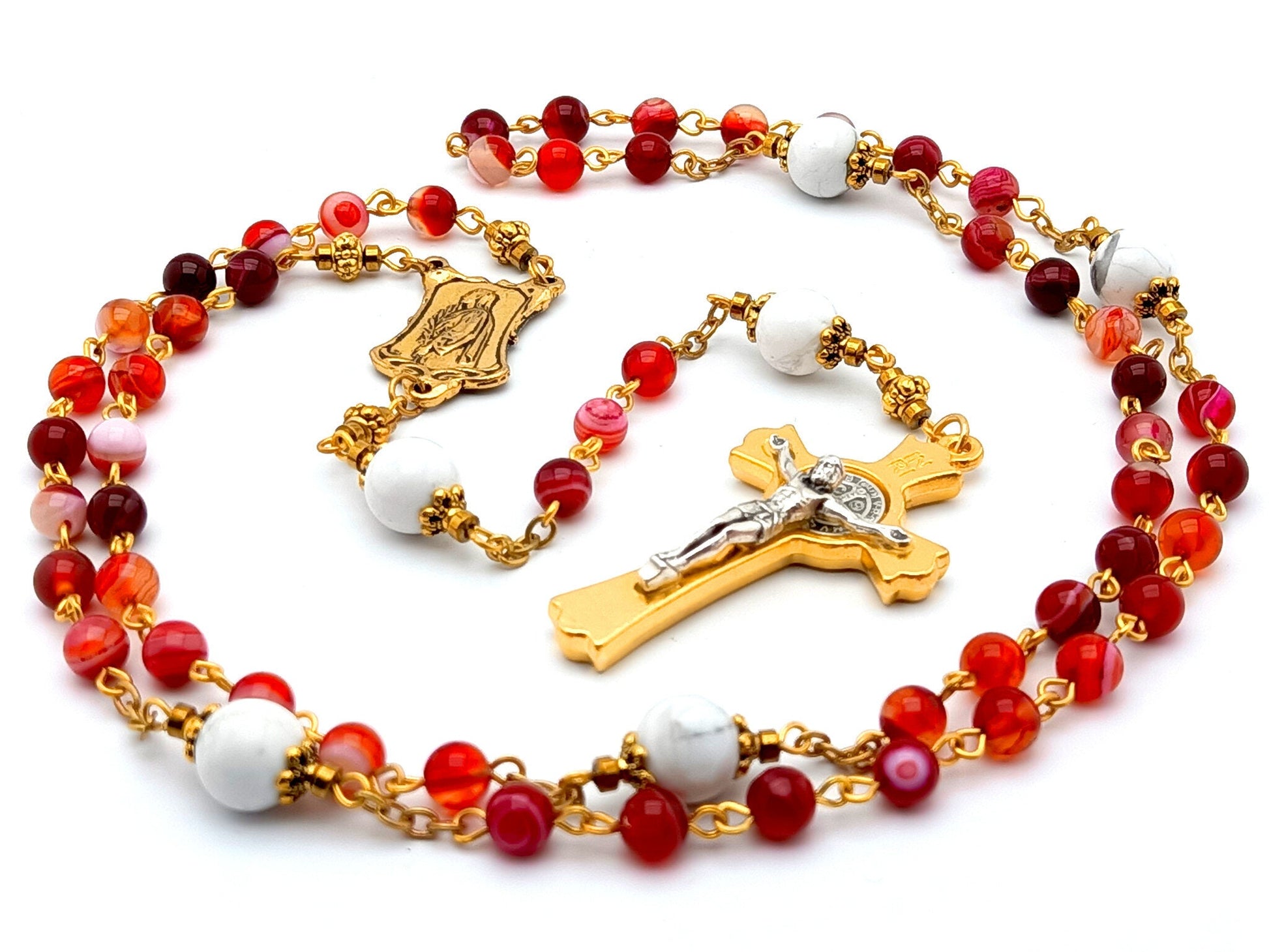 Saint John Vianney unique rosary beads with red agate and white gemstone beads, gold and silver Saint Benedict crucifix and small Saint Philomena centre medal.