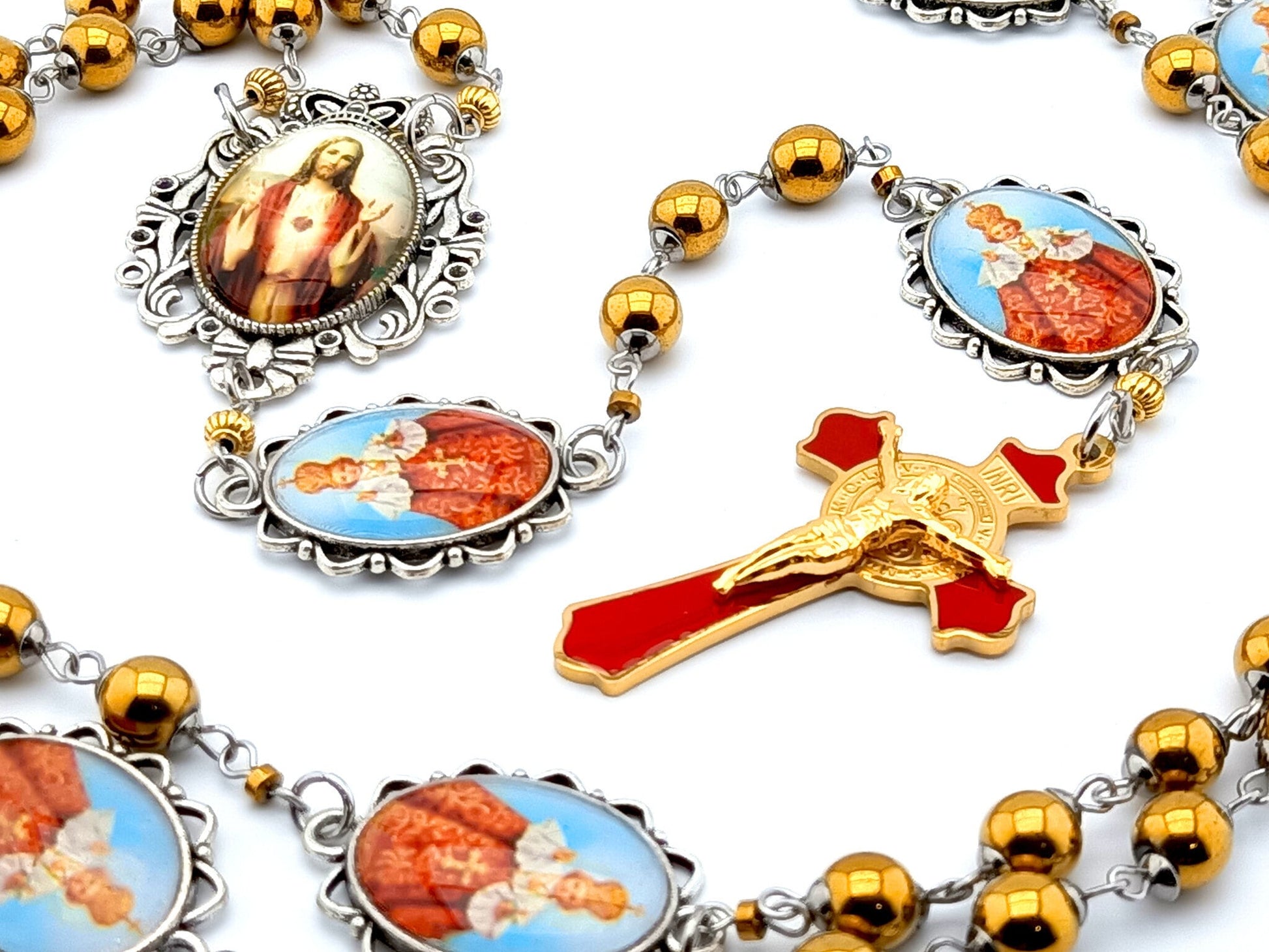 Infant of Prague unique rosary beads with gold hematite gemstone beads, Infant of Prague pater beads, gold and red enamel crucifix and silver picture centre medal.