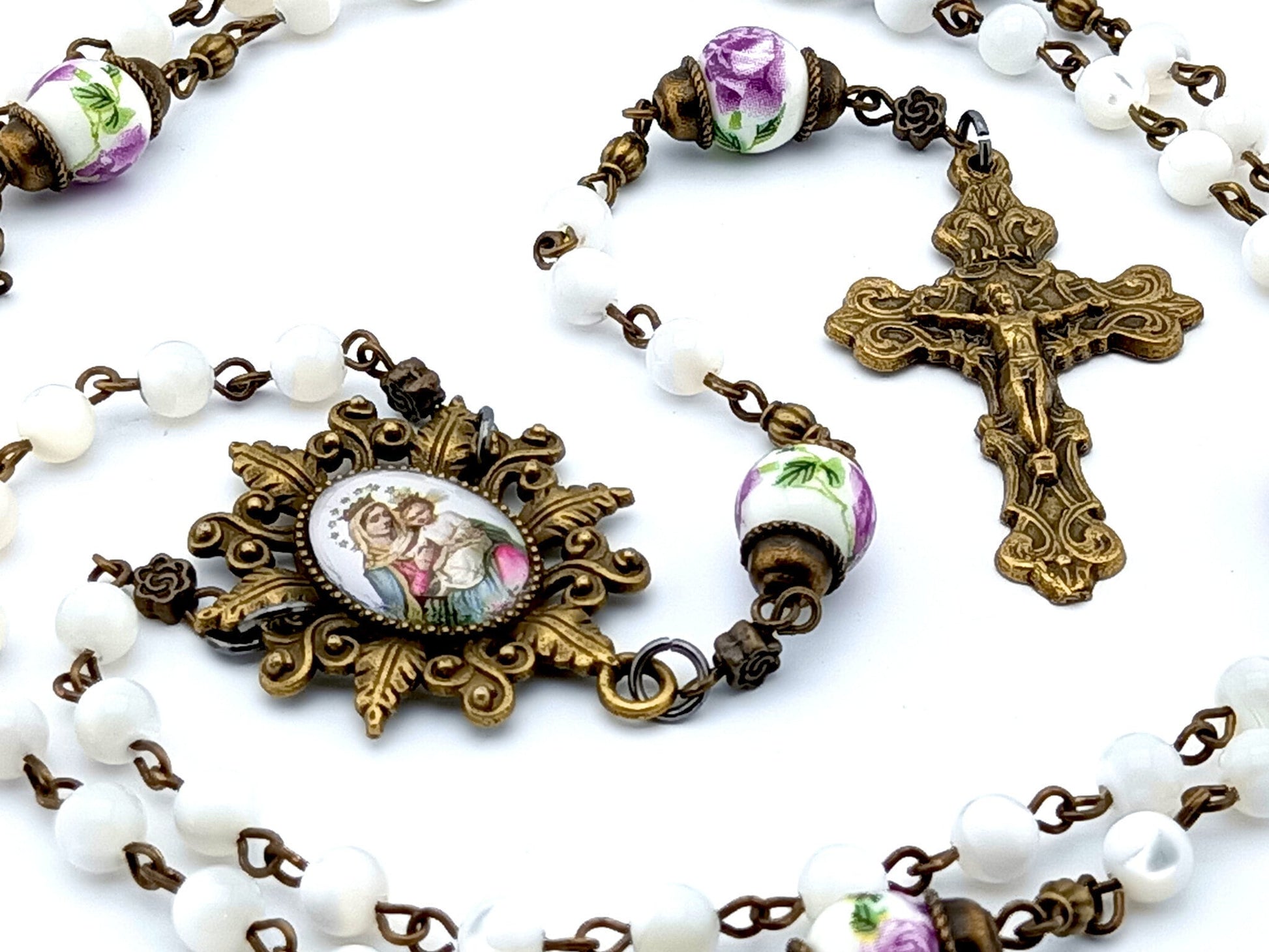 Our Lady of Perpetual Succour unique rosary beads with mother of pearl and porcelain beads, bronze crucifix, picture centre medal and accessories.