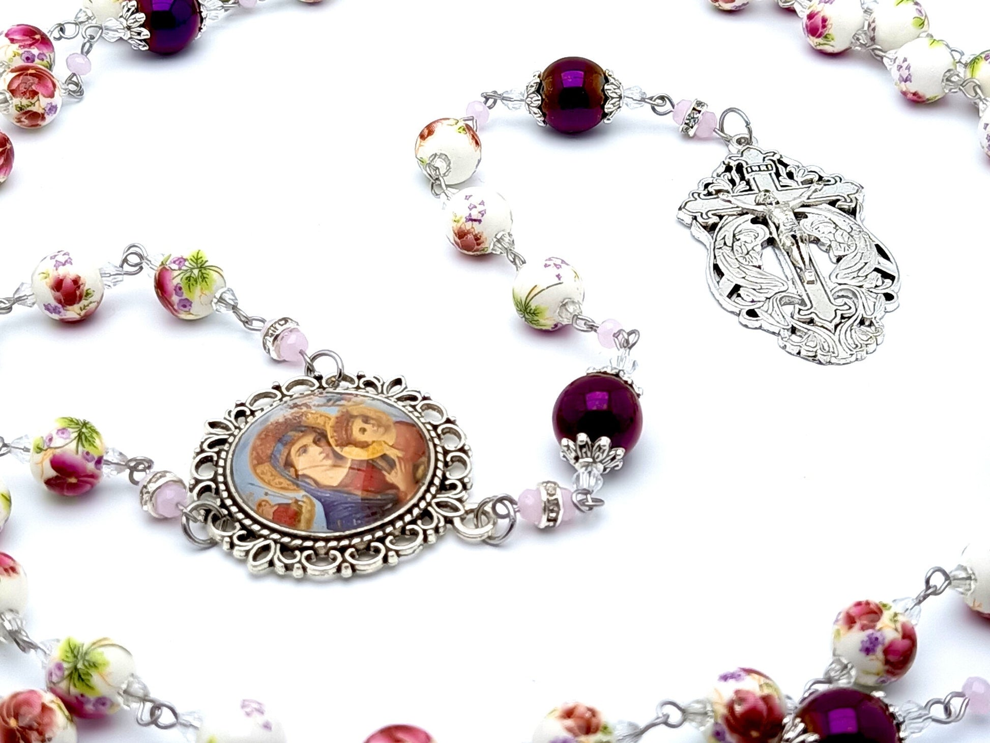 Our Lady of Perpetual Help unique rosary beads with floral porcelain and purple glass beads and Holy Angel crucifix.
